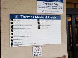 Image of Dr. Mark Brown's clinic exterior showing the building entrance with signage, clinic logo, and office hours displayed on the door.