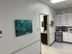 Image of Dr. Mark Brown's clinic exterior showing the building entrance with signage, clinic logo, and office hours displayed on the door.