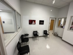 Image of Dr. Mark Brown's clinic exterior showing the building entrance with signage, clinic logo, and office hours displayed on the door.