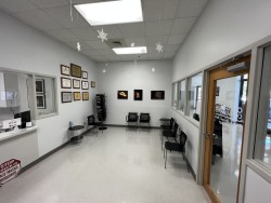 Image of Dr. Mark Brown's clinic exterior showing the building entrance with signage, clinic logo, and office hours displayed on the door.