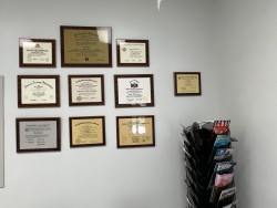 Image of Dr. Mark Brown's clinic exterior showing the building entrance with signage, clinic logo, and office hours displayed on the door.