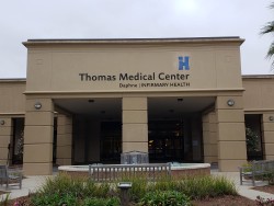 Image of Dr. Mark Brown's clinic exterior showing the building entrance with signage, clinic logo, and office hours displayed on the door.