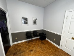 Image of Dr. Mark Brown's clinic exterior showing the building entrance with signage, clinic logo, and office hours displayed on the door.