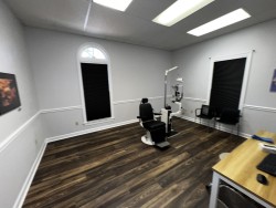 Image of Dr. Mark Brown's clinic exterior showing the building entrance with signage, clinic logo, and office hours displayed on the door.