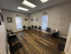 Image of Dr. Mark Brown's clinic exterior showing the building entrance with signage, clinic logo, and office hours displayed on the door.