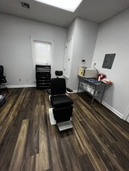 Image of Dr. Mark Brown's clinic exterior showing the building entrance with signage, clinic logo, and office hours displayed on the door.