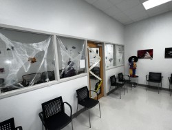 Image of Dr. Mark Brown's clinic exterior showing the building entrance with signage, clinic logo, and office hours displayed on the door.